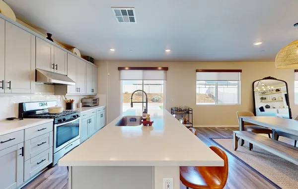 a view of a hallway with wooden floor and a potted plant