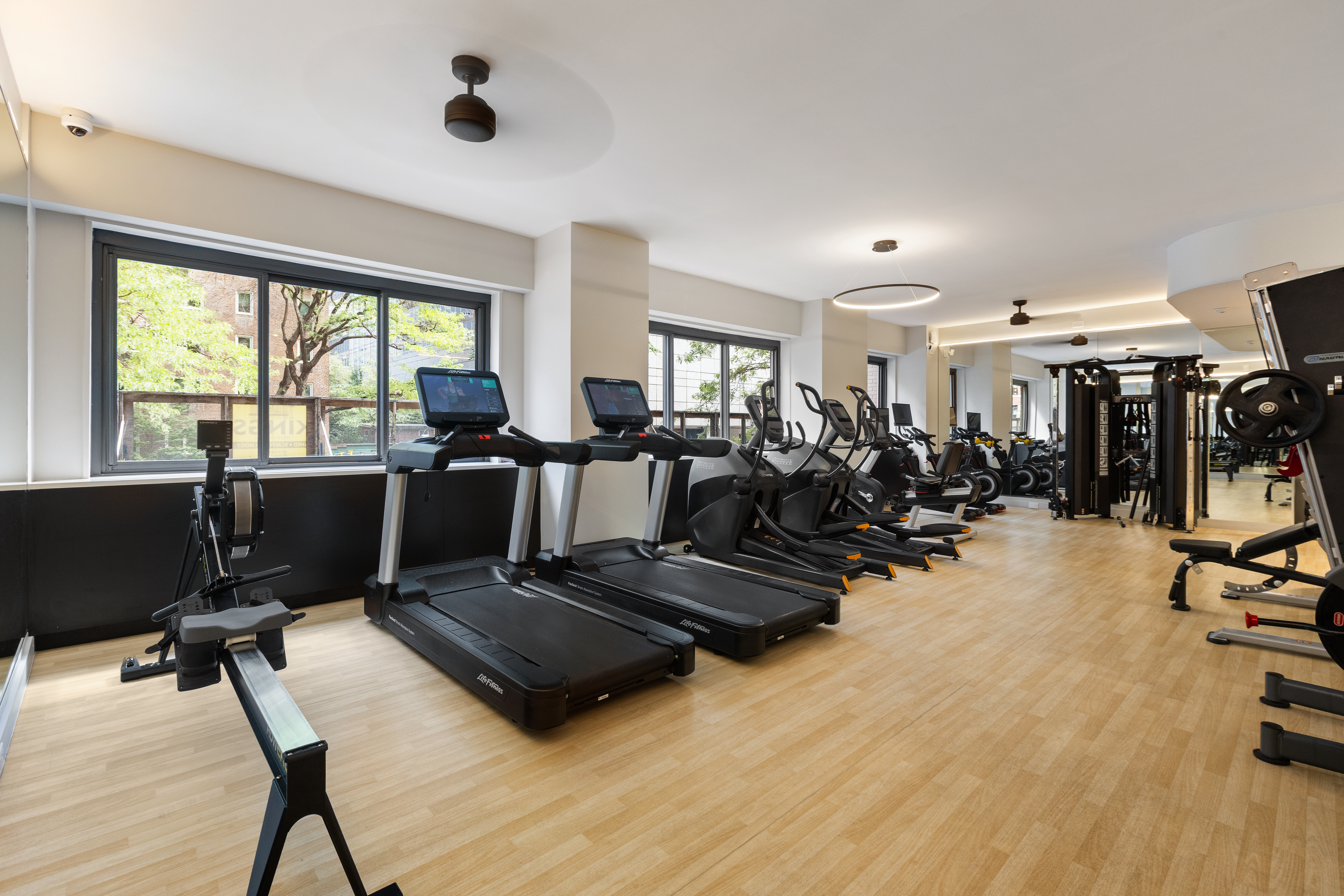 347 West 57th Street, Unit 25AB Manhattan, NY 10019 - Photo 16 of 21 a living room with furniture large window and a wooden floor
