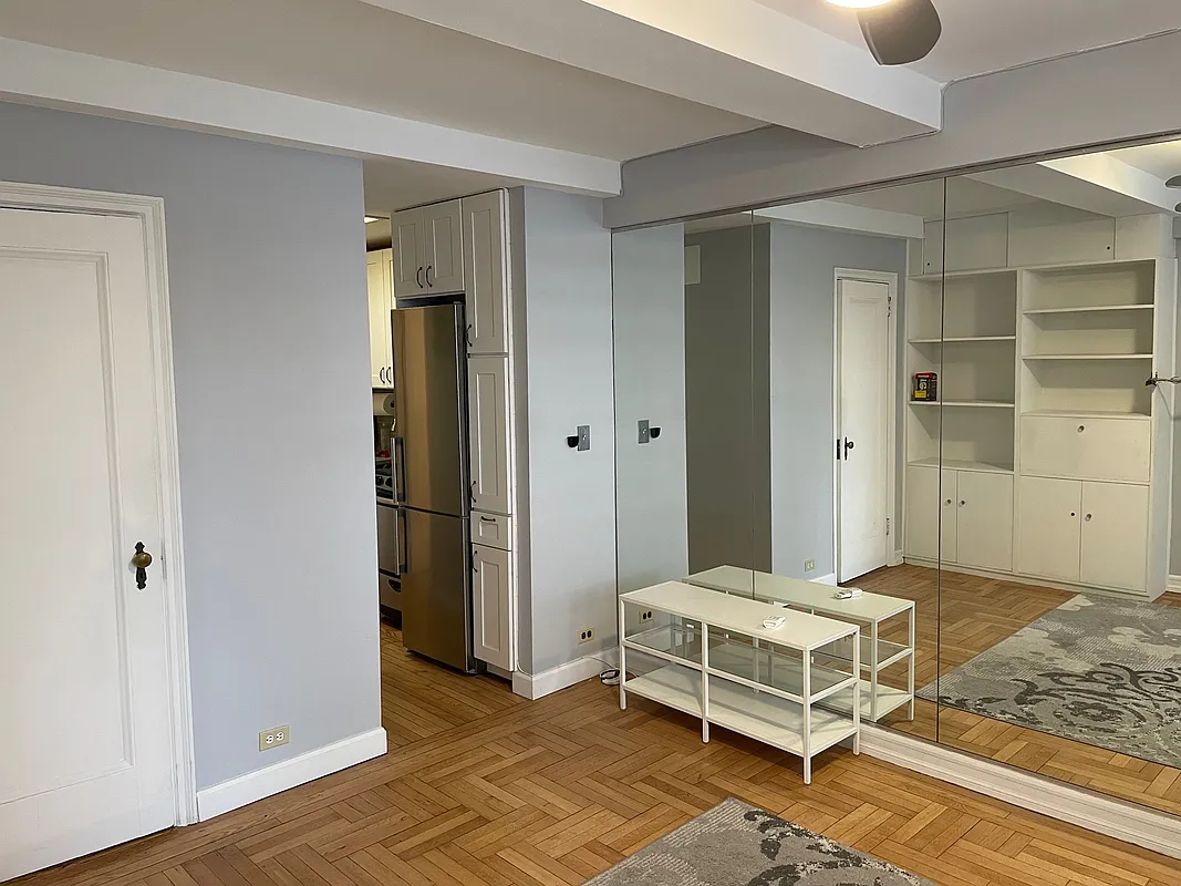 433 West 34th Street, Unit 7B Manhattan, NY 10001 - Photo 2 of 13 a bedroom with a bed and cabinets