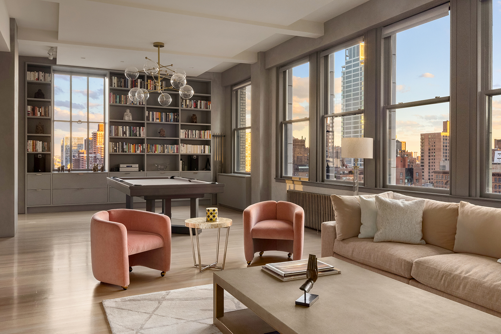 105 East 29th Street, Unit 12PH Manhattan, NY 10016 - Photo 1 of 24 a living room with furniture a chandelier and large window