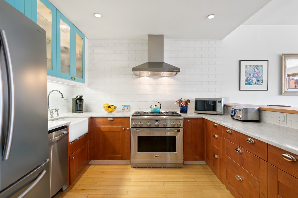 82 Visitation Place, Unit 2 Brooklyn, NY 11231 - Photo 3 of 12 a kitchen with stainless steel appliances granite countertop a stove a sink and a refrigerator