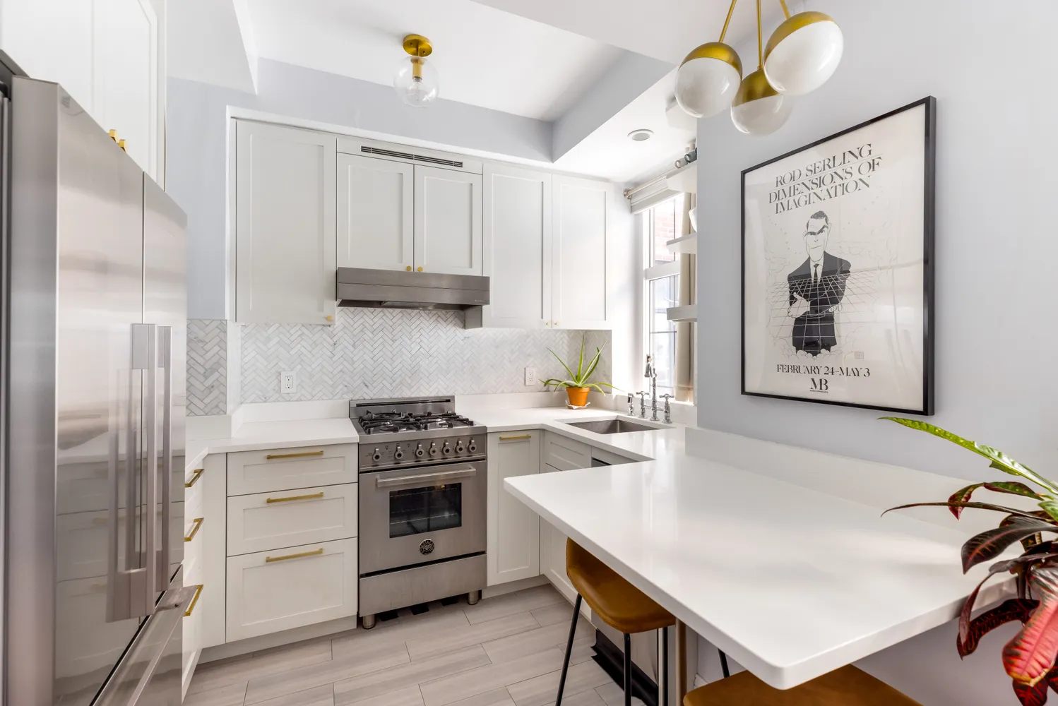 a kitchen with stainless steel appliances a stove a refrigerator and a refrigerator