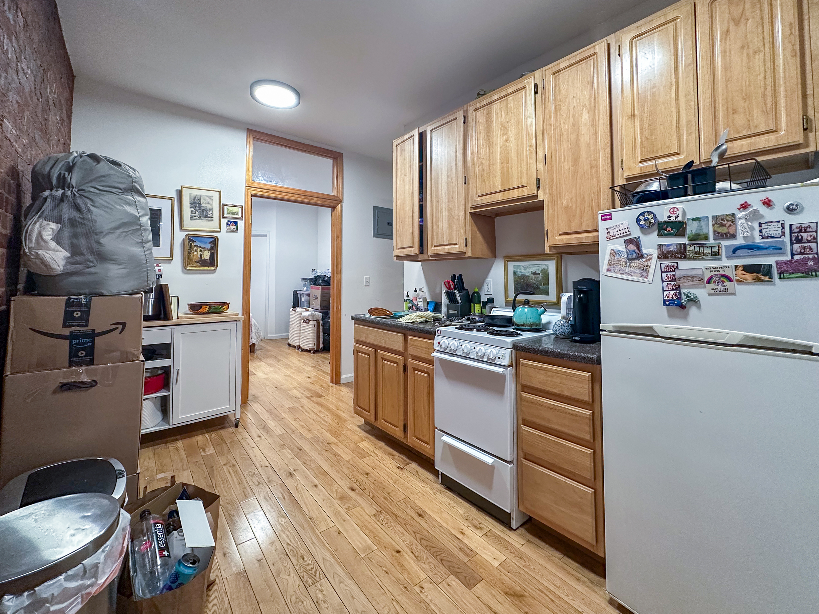 215 East 5th Street, Unit 7 Manhattan, NY 10003 - Photo 9 of 15 a kitchen with stainless steel appliances granite countertop a refrigerator a stove top oven a sink dishwasher and wooden cabinets with wooden floor