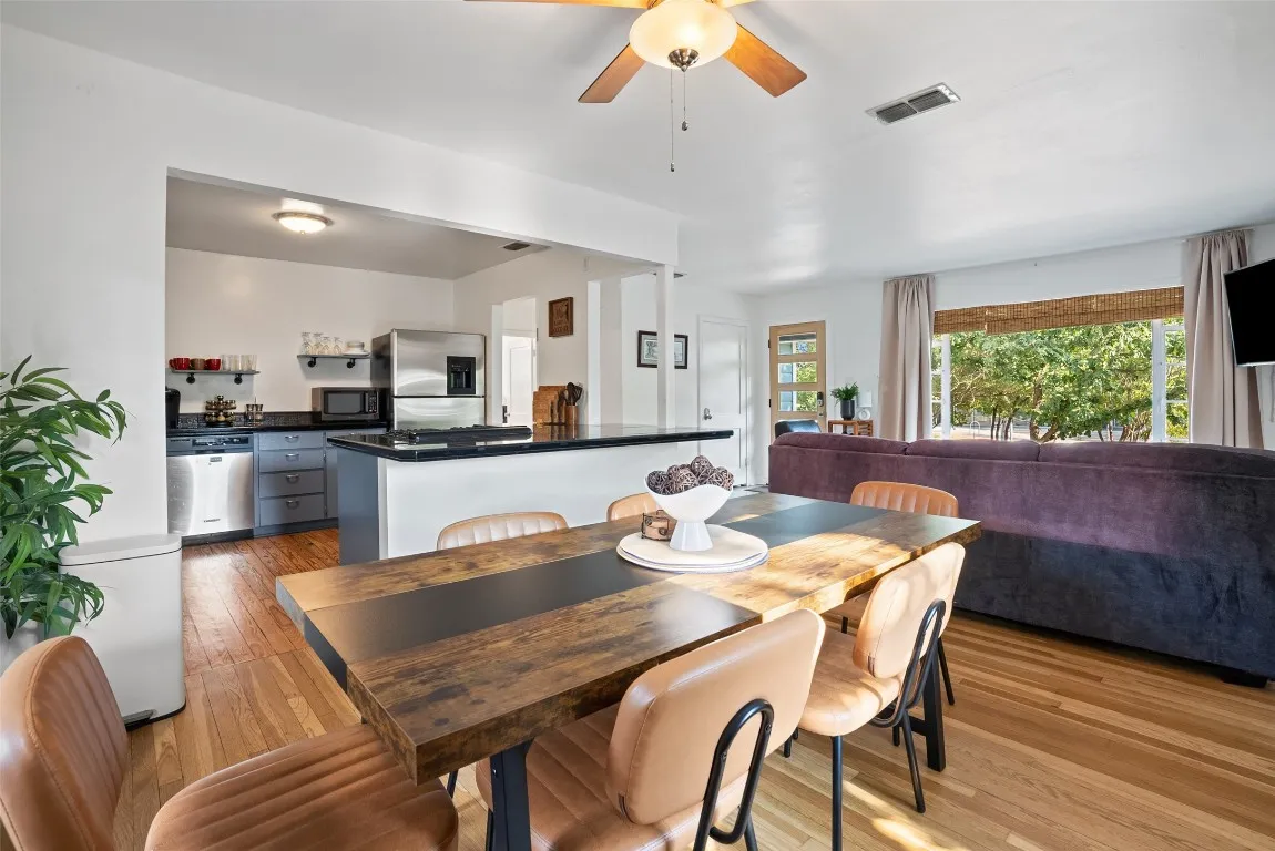 a view of a dining room with furniture and wooden floor
