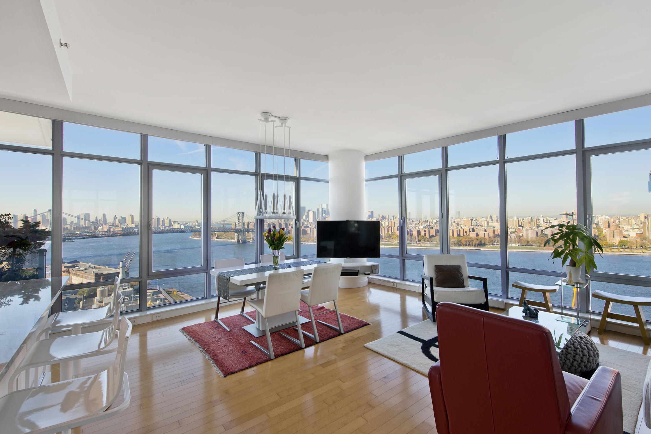 1 Northside Piers, Unit 25D Brooklyn, NY 11249 - Photo 1 of 19 a living room with furniture large windows and a flat screen tv