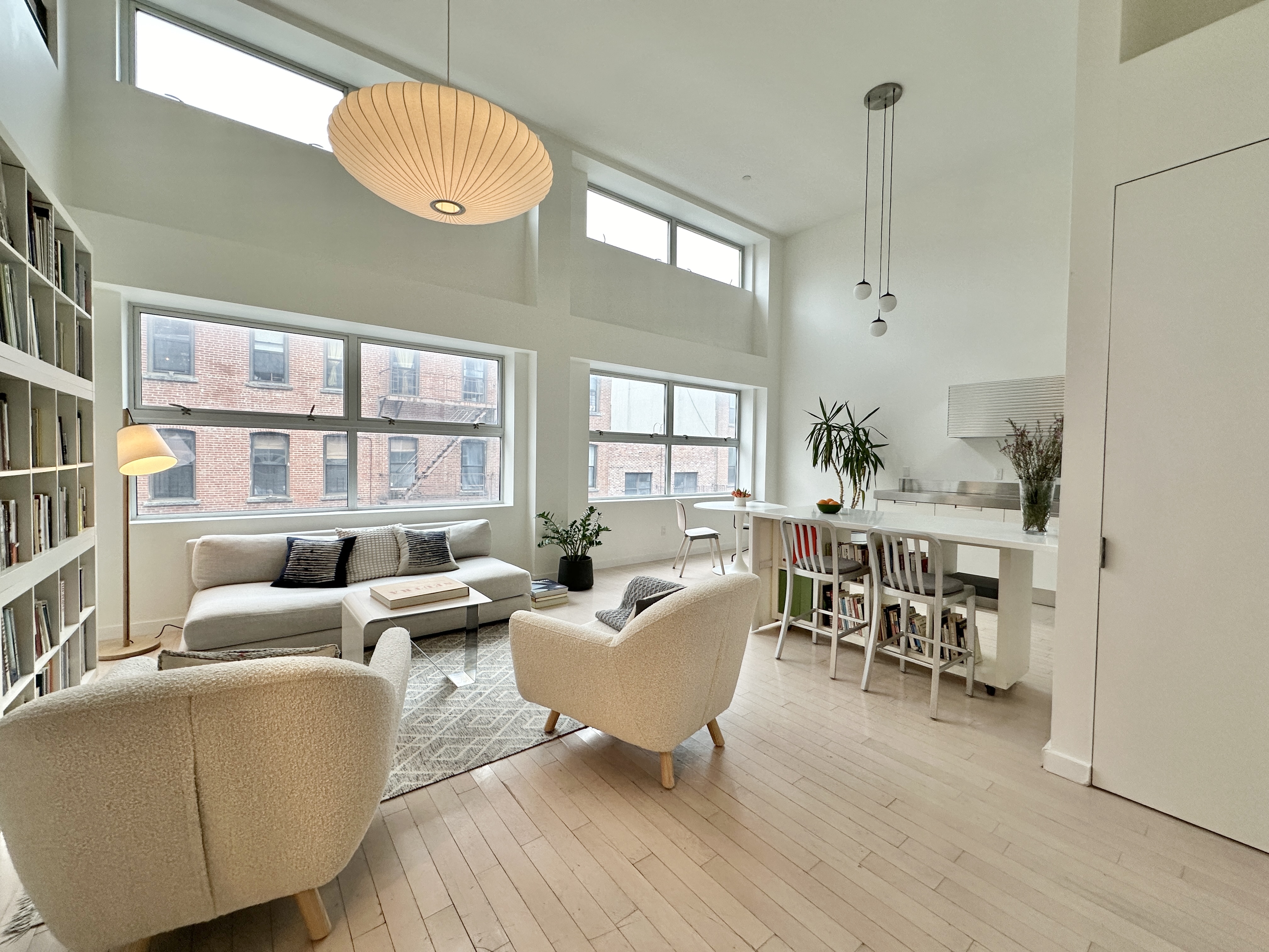 100 North 3rd Street, Unit 3E Brooklyn, NY 11249 - Photo 3 of 15 a living room with furniture wooden floor and a large window