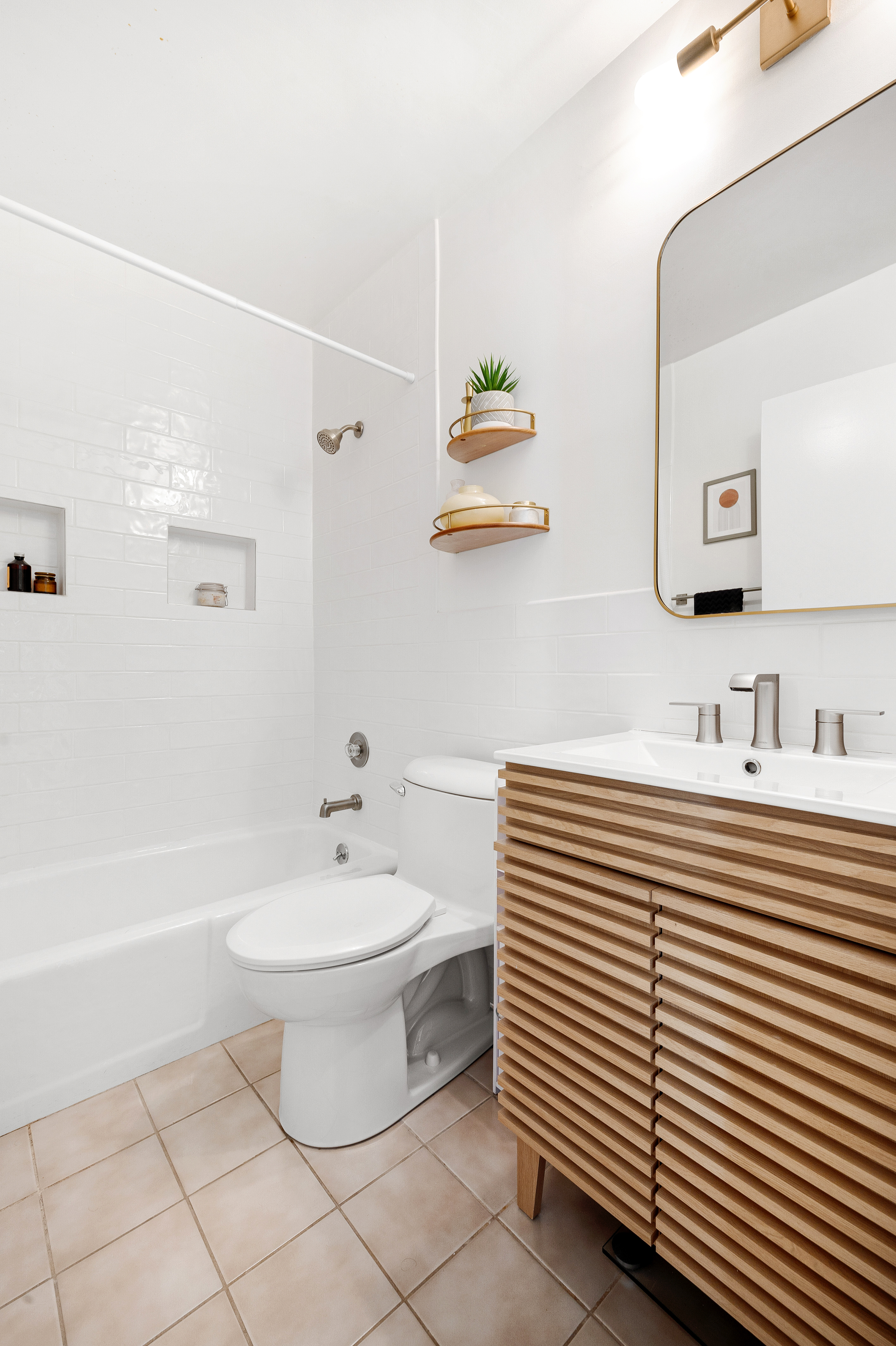 2025 Broadway, Unit 9F Manhattan, NY 10023 - Photo 7 of 11 a bathroom with a sink toilet and shower