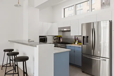 a kitchen with stainless steel appliances a refrigerator stove and microwave