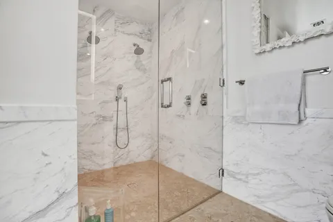 a bathroom with a glass shower door