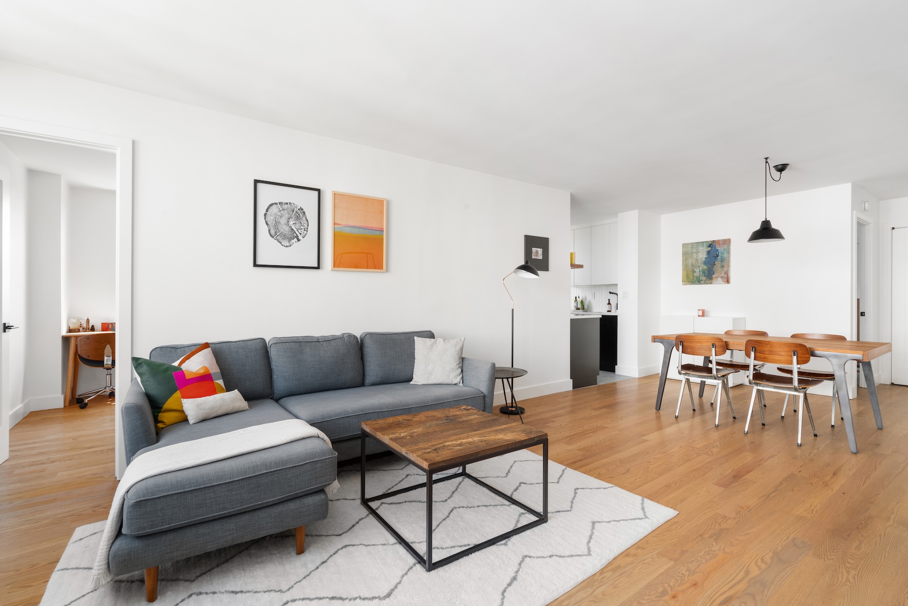 201 East 17th Street, Unit 16H Manhattan, NY 10003 - Photo 3 of 16 a living room with furniture and a dining table