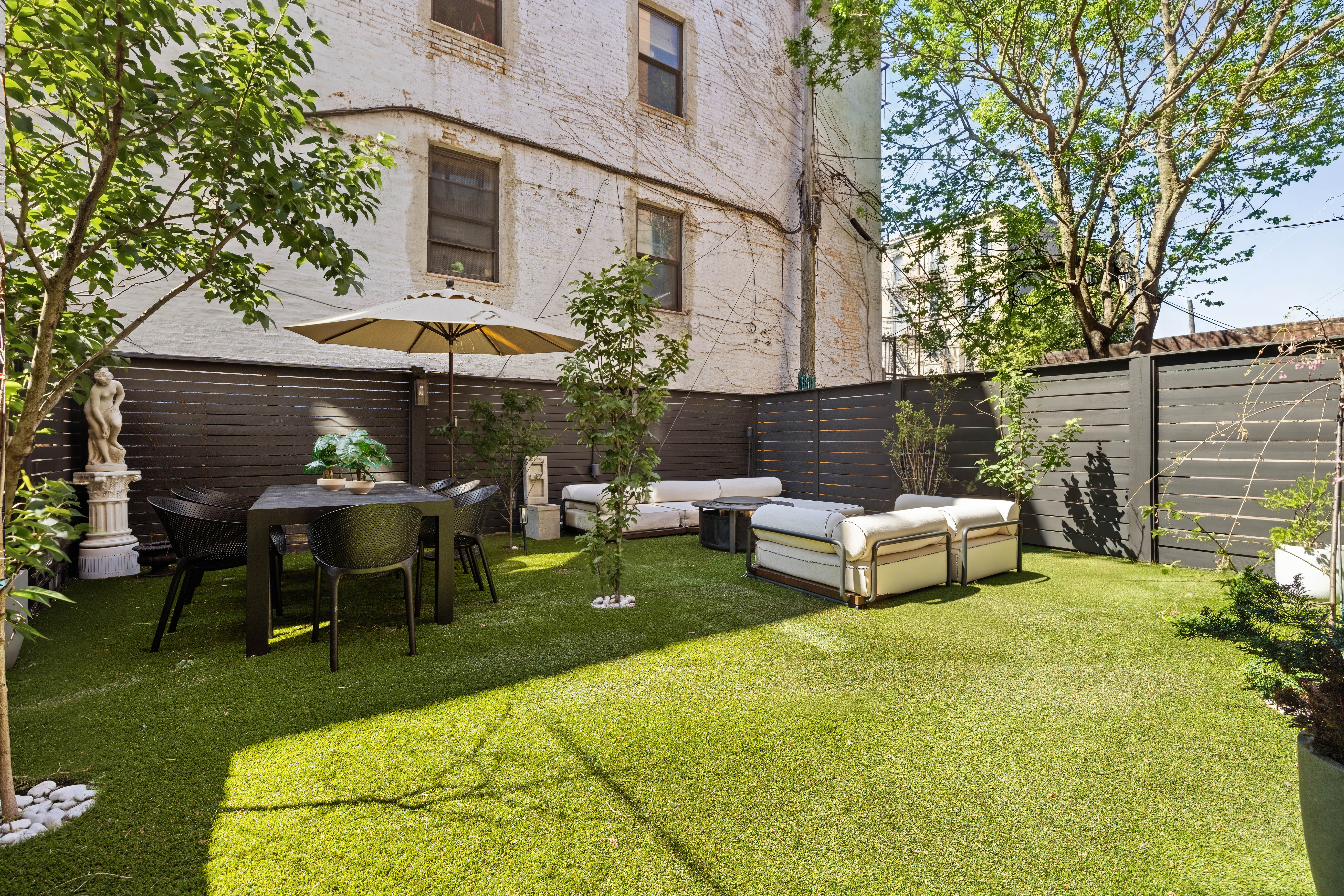 1404 Bushwick Avenue, Unit 1F Brooklyn, NY 11207 - Photo 12 of 18 a view of a patio with table and chairs under an umbrella