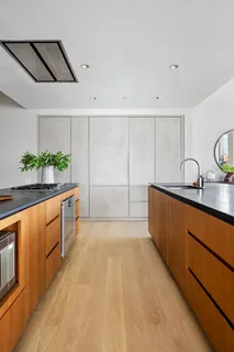 a large kitchen with stainless steel appliances a stove a sink and a refrigerator