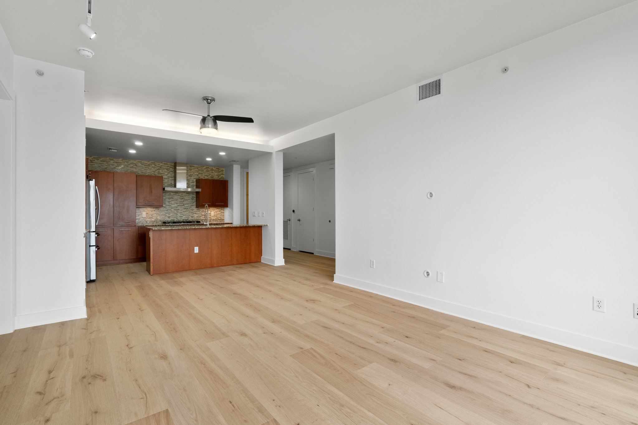 210 Lee Barton Drive, Unit 517 Austin, TX 78704 - Photo 10 of 32 a view of a kitchen with a sink and a refrigerator
