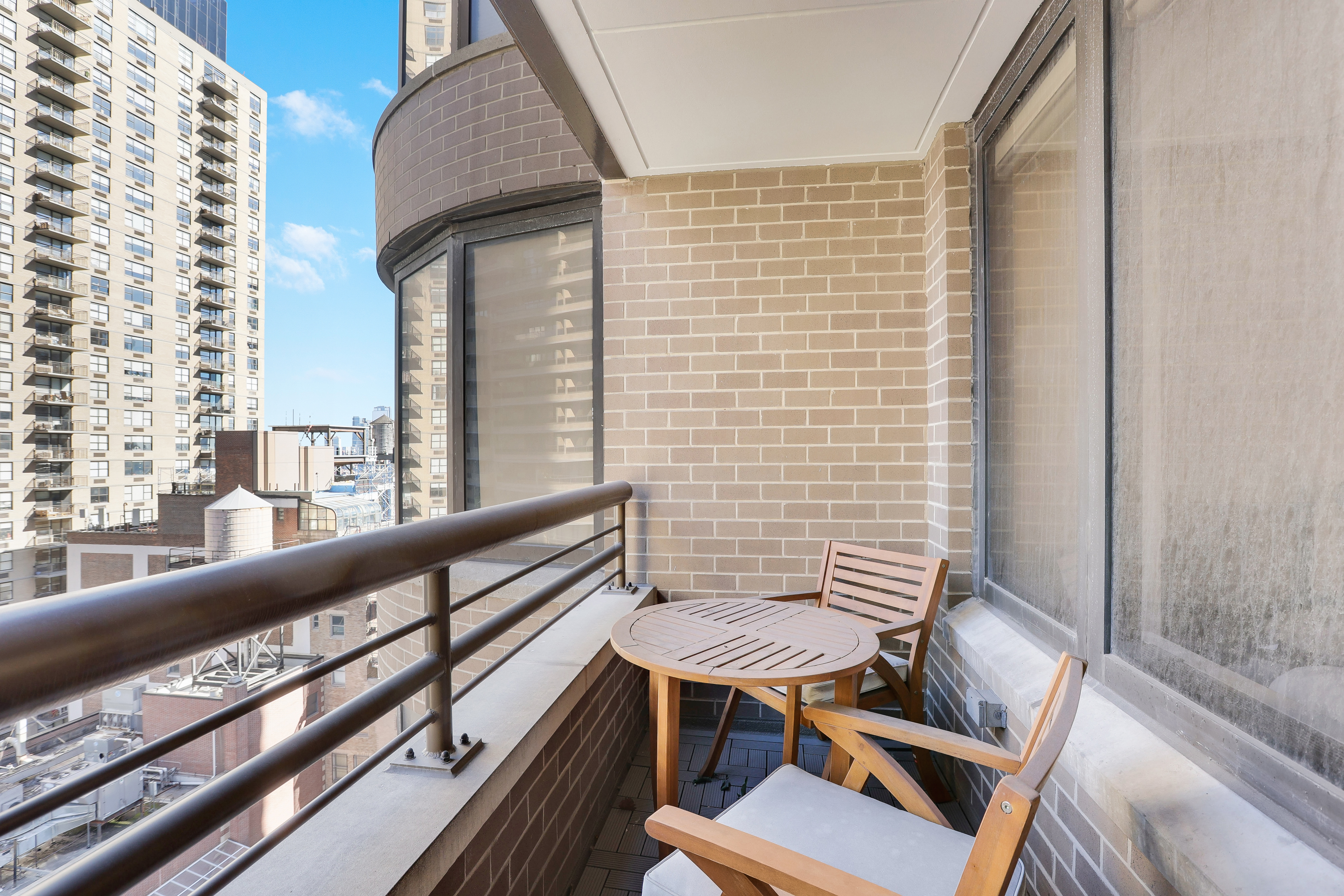 330 East 38th Street, Unit 20E Manhattan, NY 10016 - Photo 7 of 17 a view of balcony with wooden floor and outdoor seating