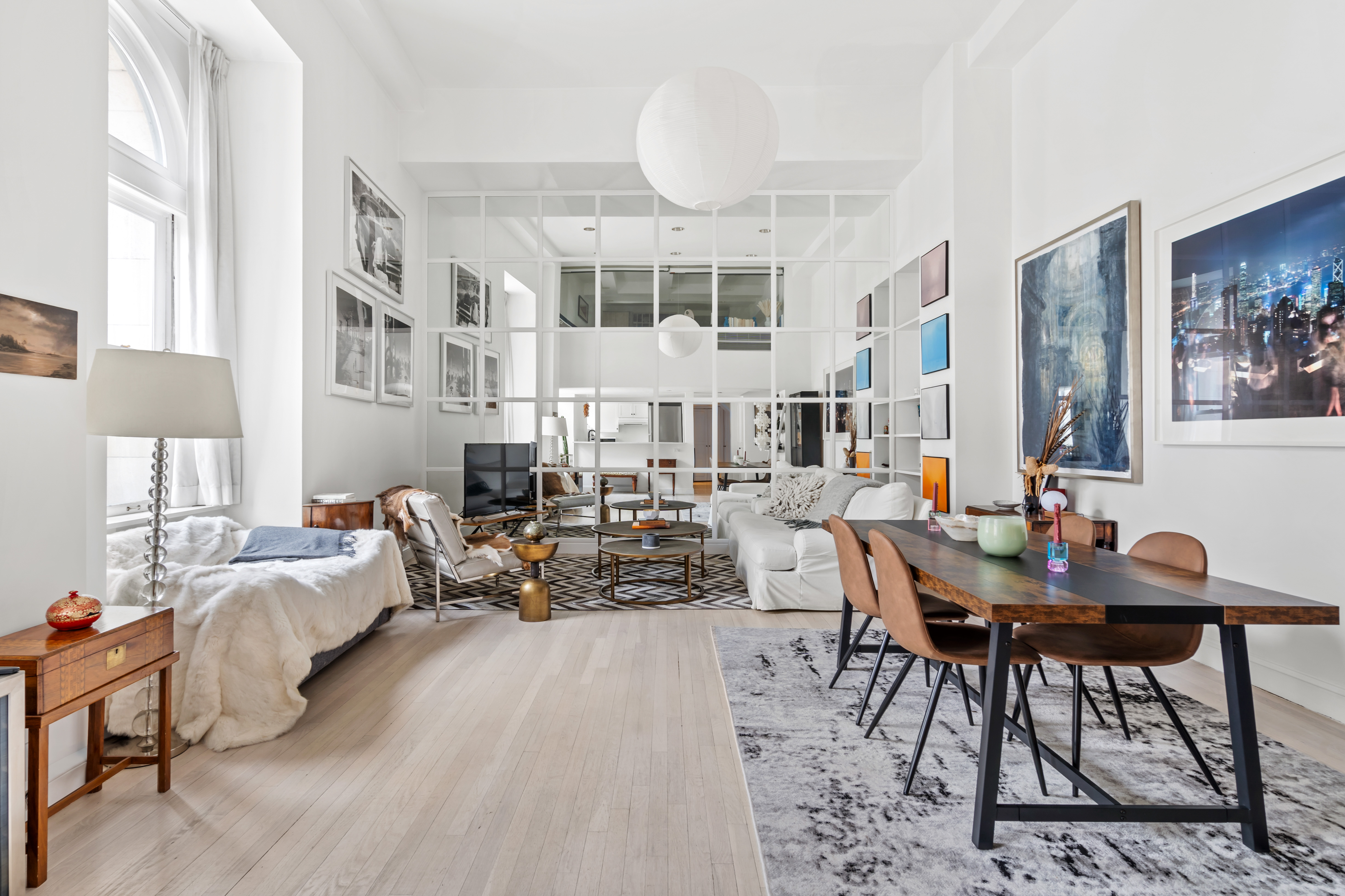 240 Centre Street, Unit 2N Manhattan, NY 10013 - Photo 2 of 16 a living room with furniture and a chandelier