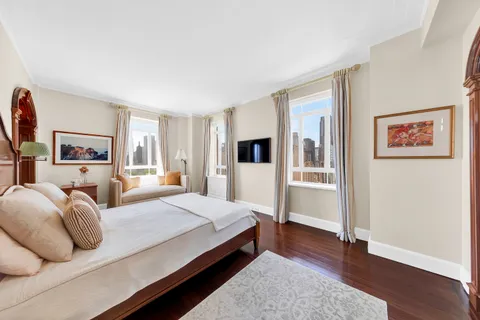 a spacious bedroom with a bed and a couch