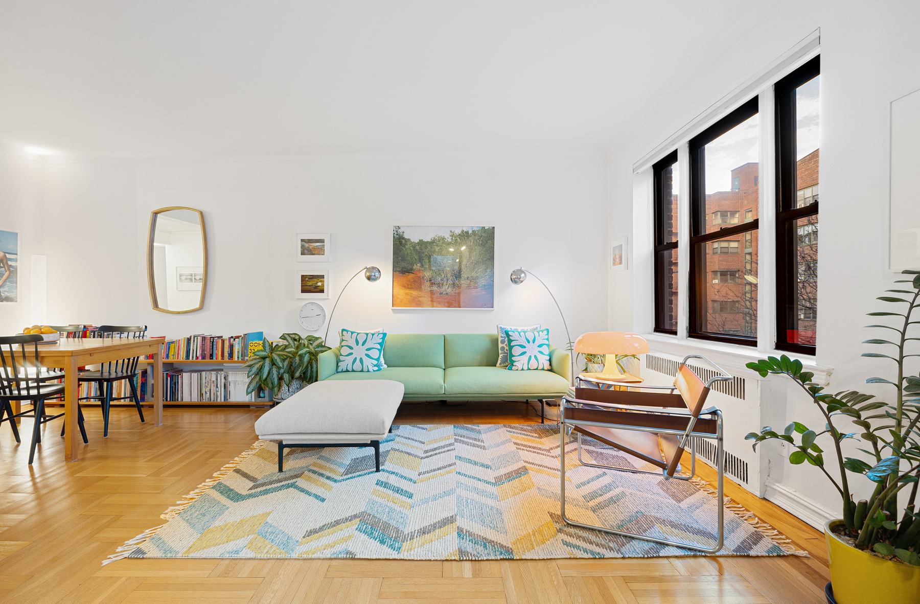 77-11 35th Avenue, Unit 3N Queens, NY 11372 - Photo 2 of 21 a living room with furniture and a large window