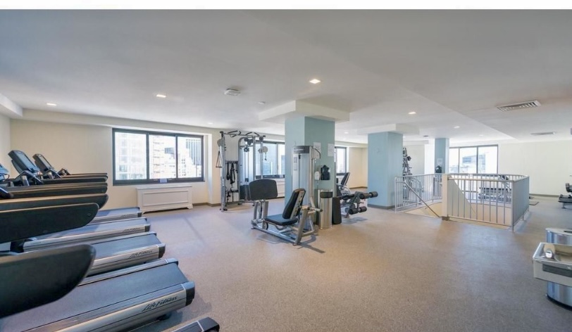 200 Rector Place, Unit 2C Manhattan, NY 10280 - Photo 14 of 19 a living room with furniture and wooden floor