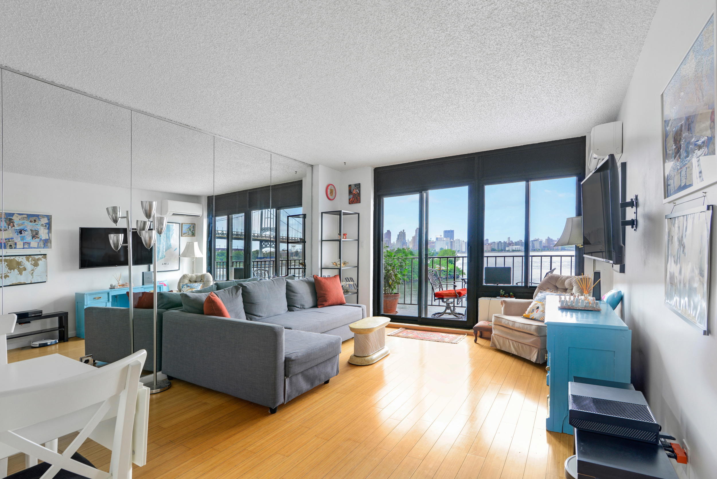 2540 Shore Boulevard, Unit 4S Queens, NY 11102 - Photo 2 of 21 a living room with furniture and a flat screen tv