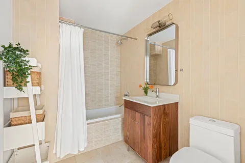 a bathroom with a toilet a sink and a mirror