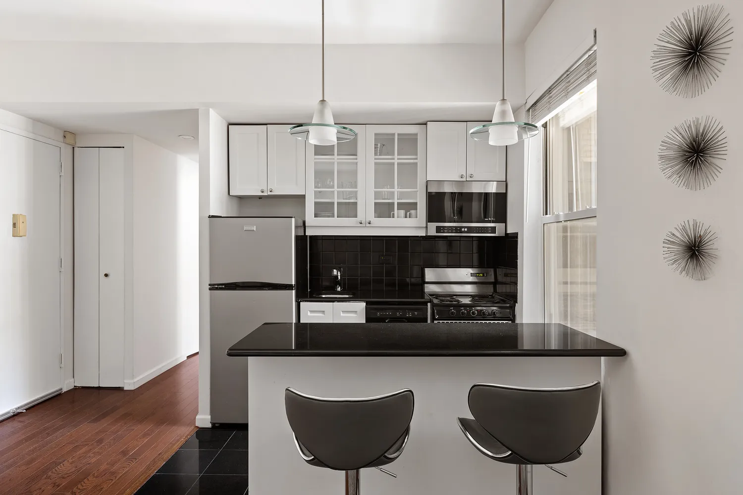 a kitchen with stainless steel appliances granite countertop a microwave a stove and refrigerator