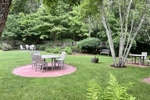 a view of a house with a backyard porch and sitting area