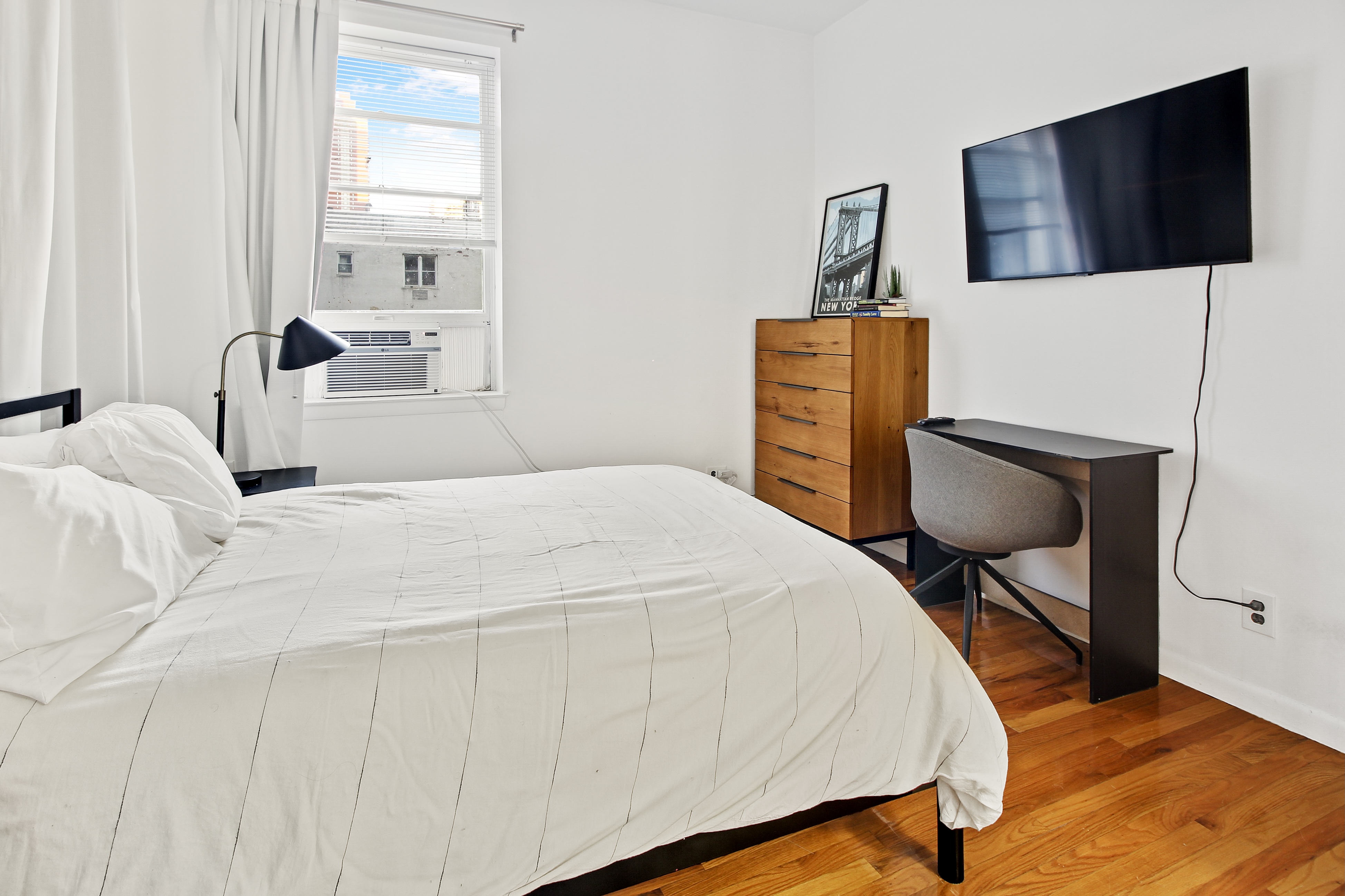 621 2nd Avenue, Unit 2 Manhattan, NY 10016 - Photo 7 of 8 a bedroom with a bed and wooden floor