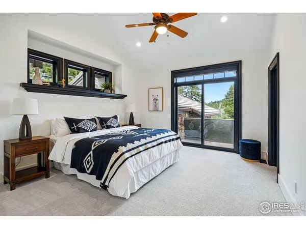 a bedroom with a large bed and a chandelier
