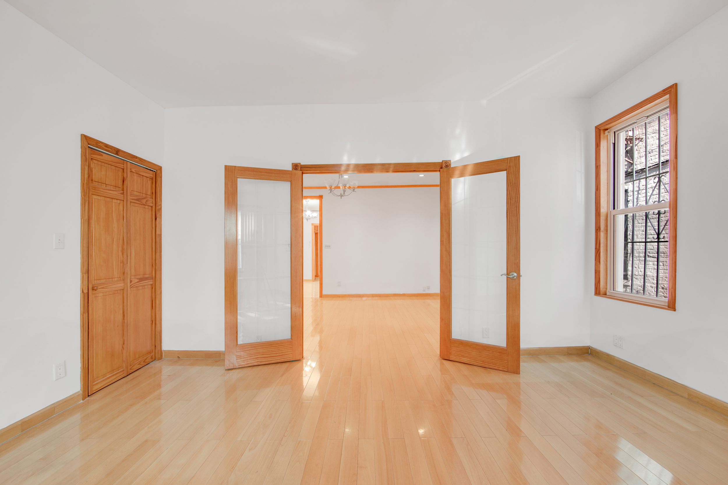 1759 West 1st Street Brooklyn, NY 11223 - Photo 4 of 21 a view of an empty room with wooden floor and a window