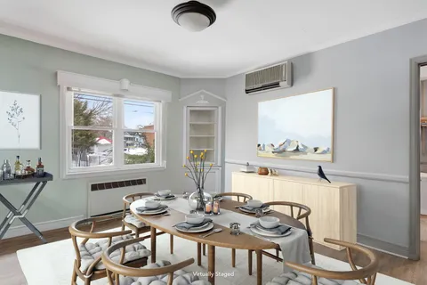 a view of a dining room with furniture and chandelier