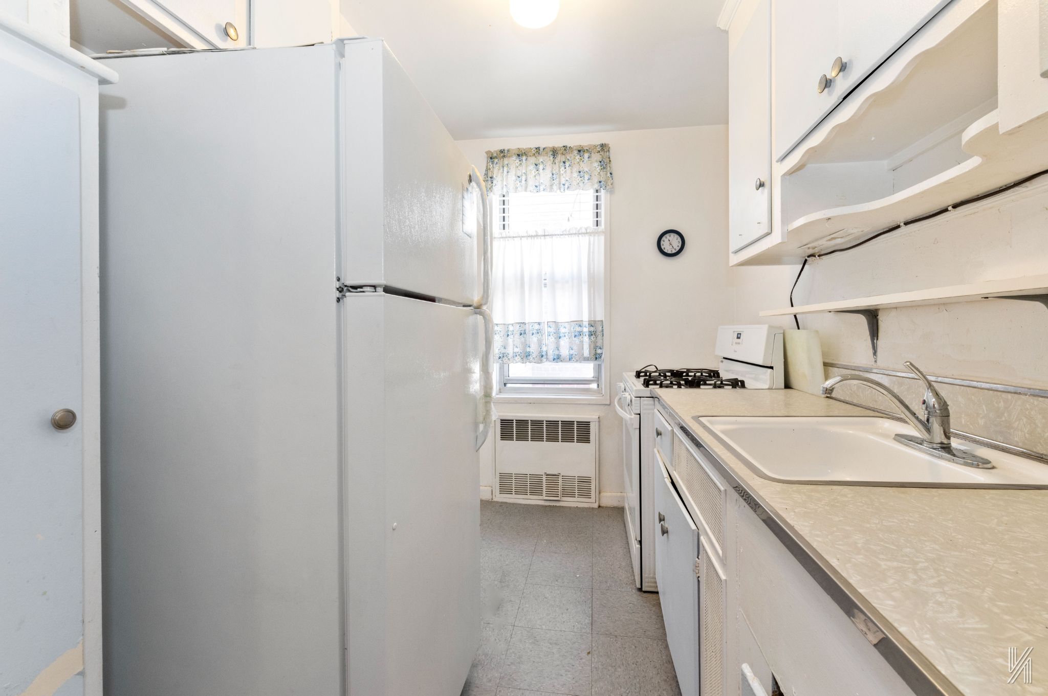 33-45 92nd Street, Unit 5G Queens, NY 11372 - Photo 4 of 8 a kitchen with a sink stove and refrigerator