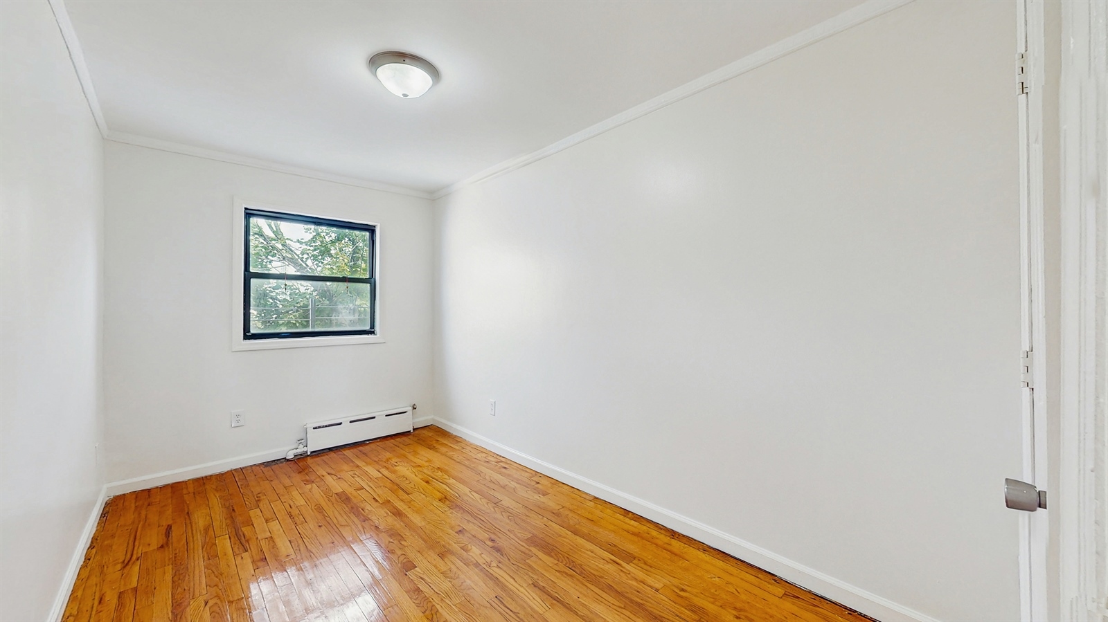 295 Conklin Avenue, Unit 3 Brooklyn, NY 11236 - Photo 11 of 15 an empty room with a window