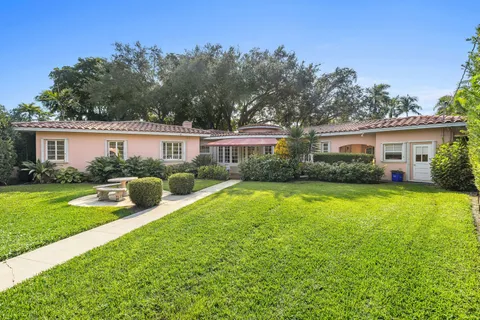a view of a house with a yard patio and swimming pool