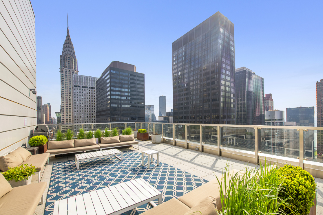 325 Lexington Avenue, Unit 15C Manhattan, NY 10016 - Photo 15 of 16 a view of roof deck with a barbeque and wooden stairs