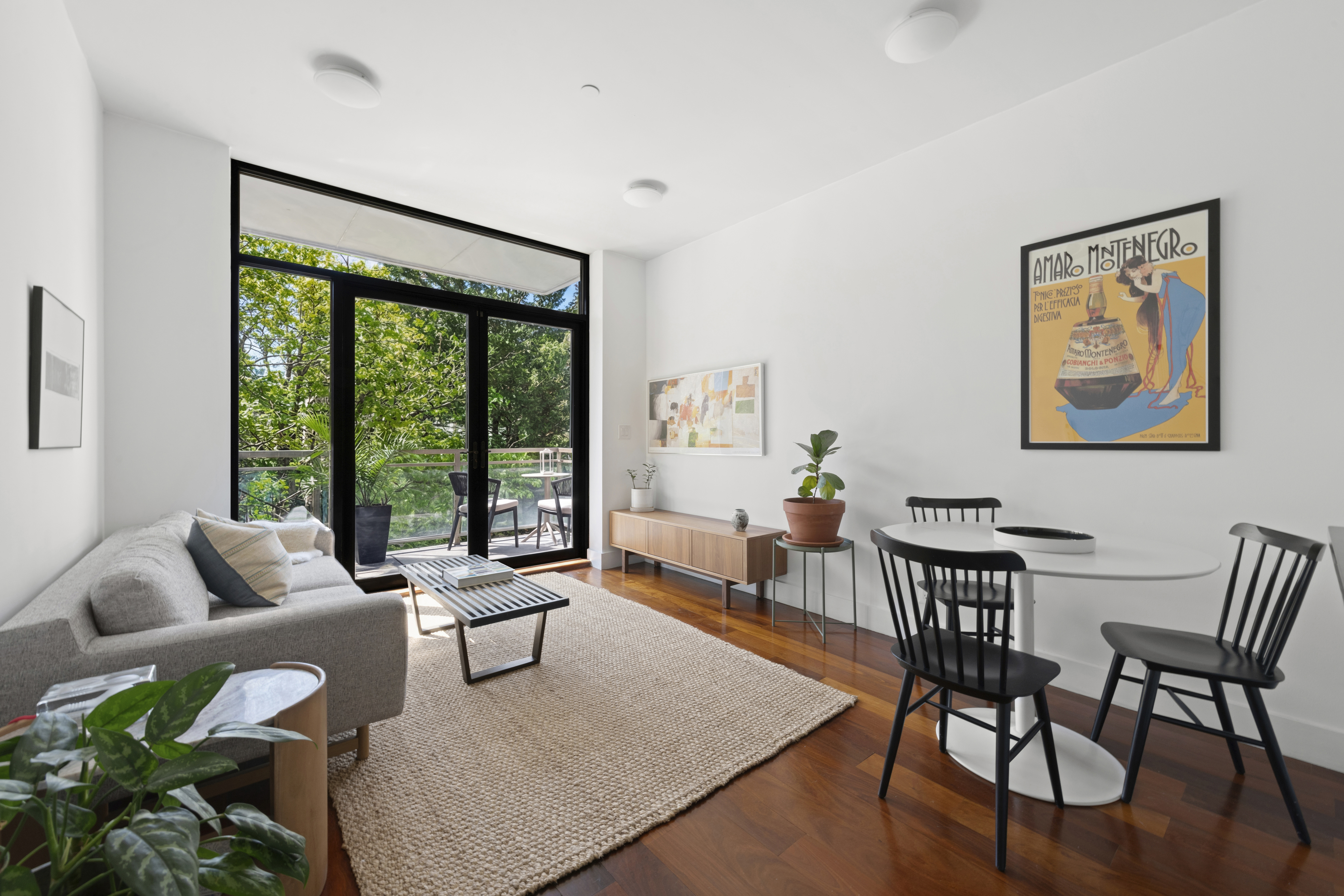 82 Adelphi Street, Unit 3D Brooklyn, NY 11205 - Photo 3 of 7 a living room with furniture and a large window