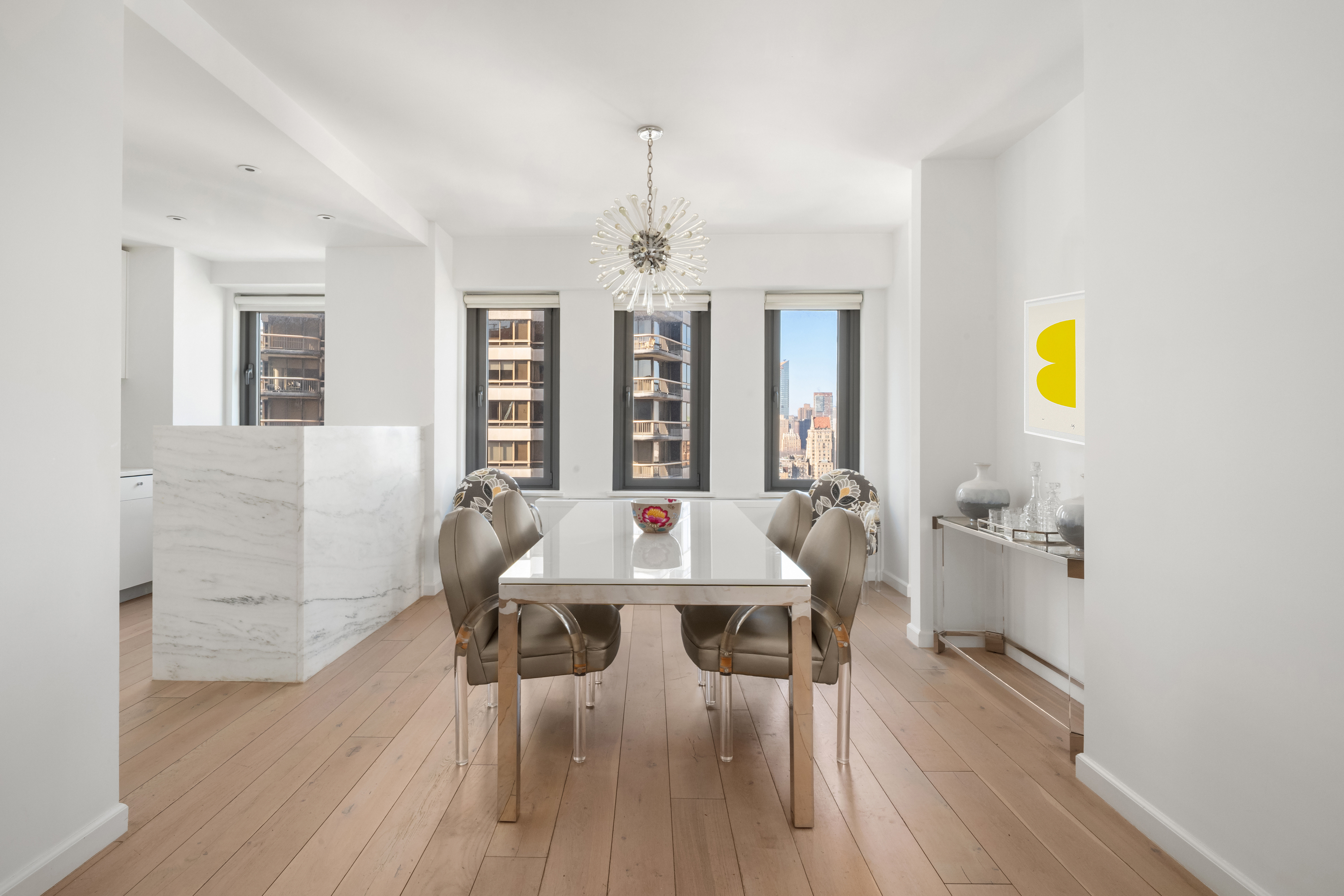 200 East 62nd Street, Unit 27A Manhattan, NY 10065 - Photo 4 of 19 a view of a dining room with furniture and chandelier