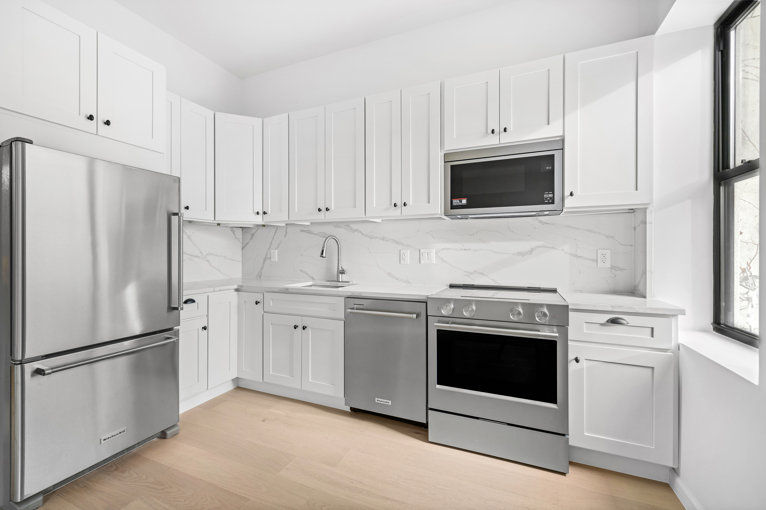 317 Court Street, Unit 2 Brooklyn, NY 11231 - Photo 4 of 14 a kitchen with white cabinets and stainless steel appliances