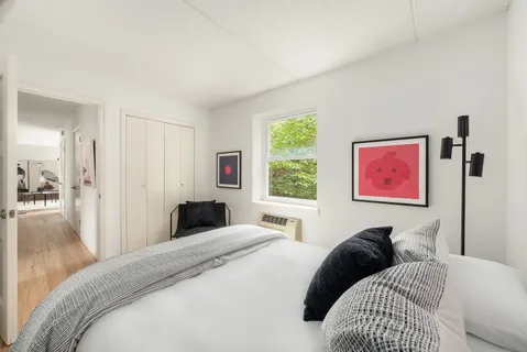 a bedroom with a bed and a large mirror