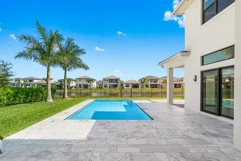 a view of an house with swimming pool and yard