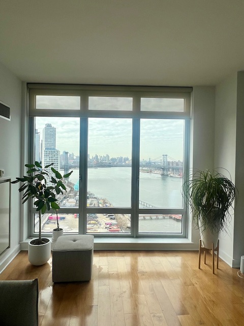 2 Northside Piers, Unit 26C Brooklyn, NY 11249 - Photo 4 of 21 a living room with furniture and a large window
