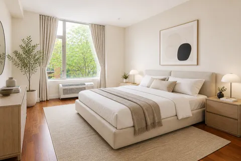 a bedroom with a bed and a large window