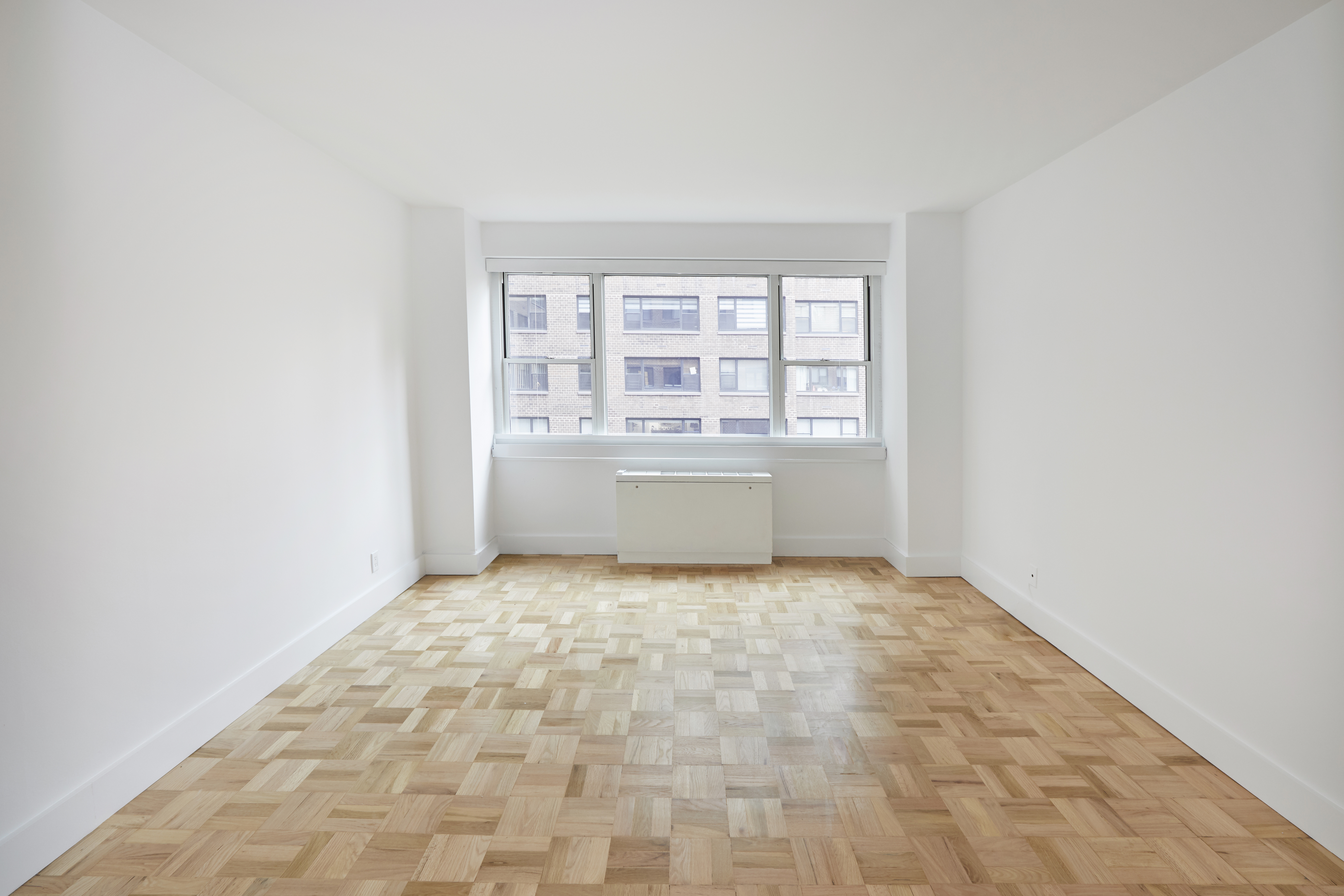 340 East 64th Street, Unit 5B Manhattan, NY 10065 - Photo 5 of 19 an empty room with a empty space and windows