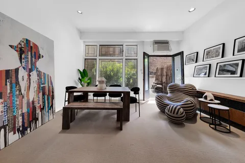 a living room with furniture and a floor to ceiling window
