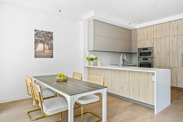 a kitchen with a table chairs and a refrigerator