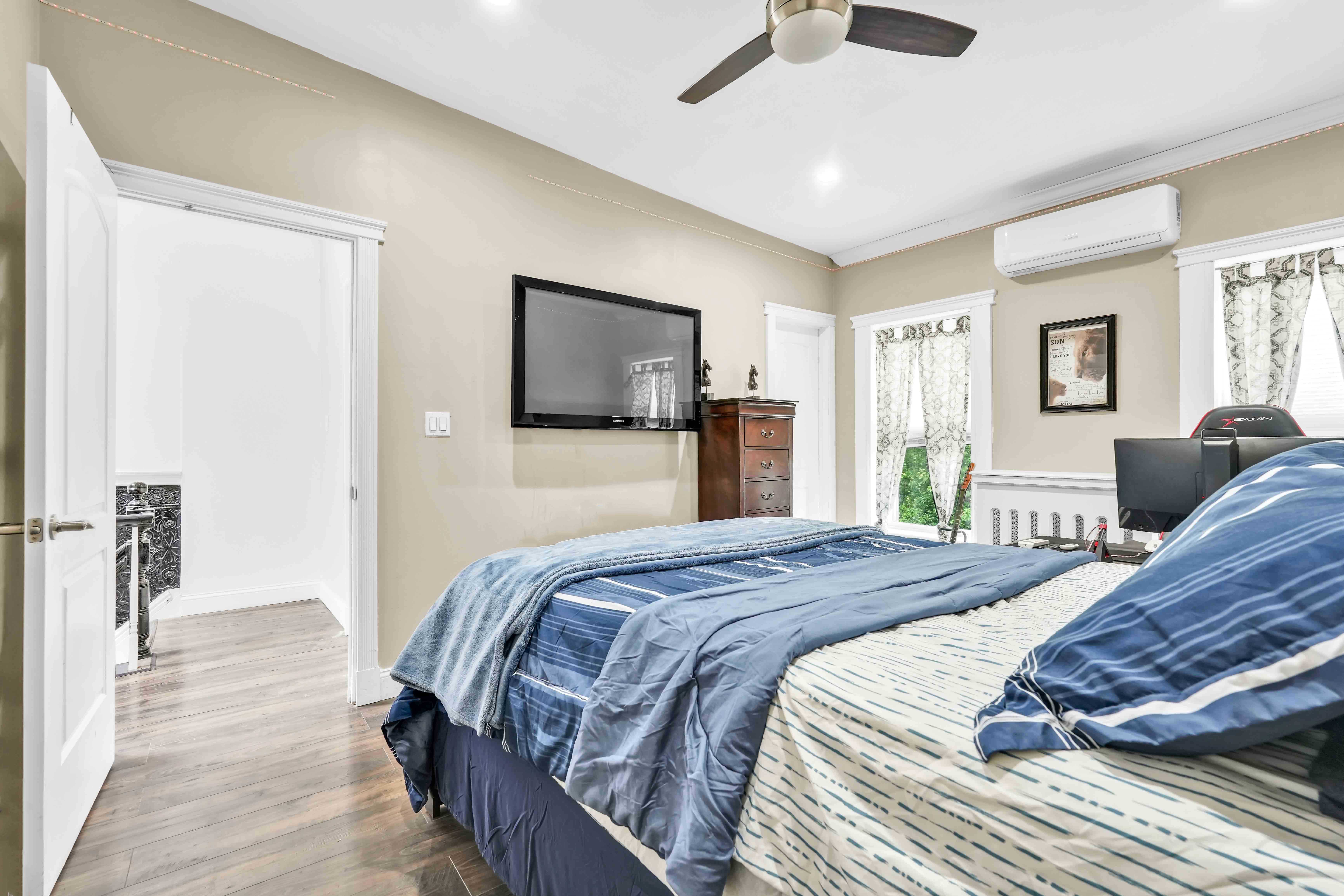 519 Monroe Street Brooklyn, NY 11221 - Photo 22 of 55 a bedroom with a bed and wooden floor