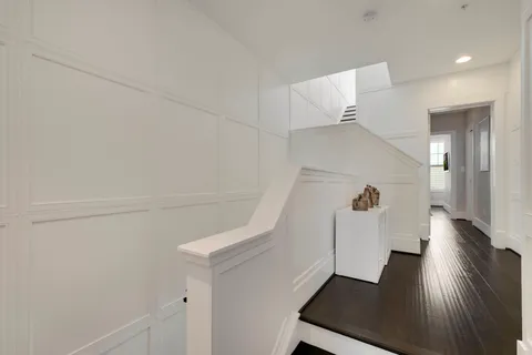 a view of entryway and hall with wooden floor