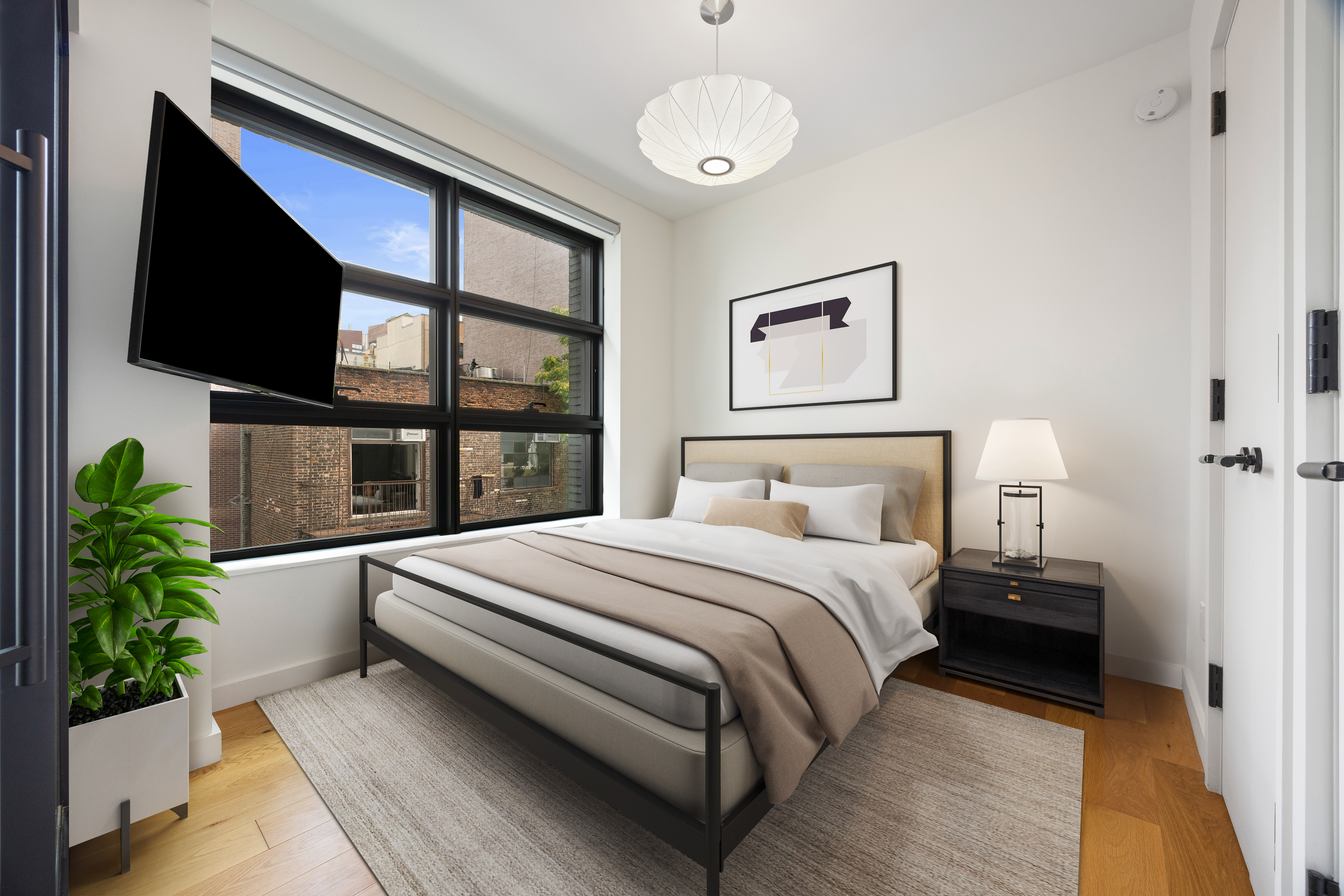 547 West 47th Street, Unit 509 Manhattan, NY 10036 - Photo 10 of 29 a bedroom with a large bed and a flat tv screen