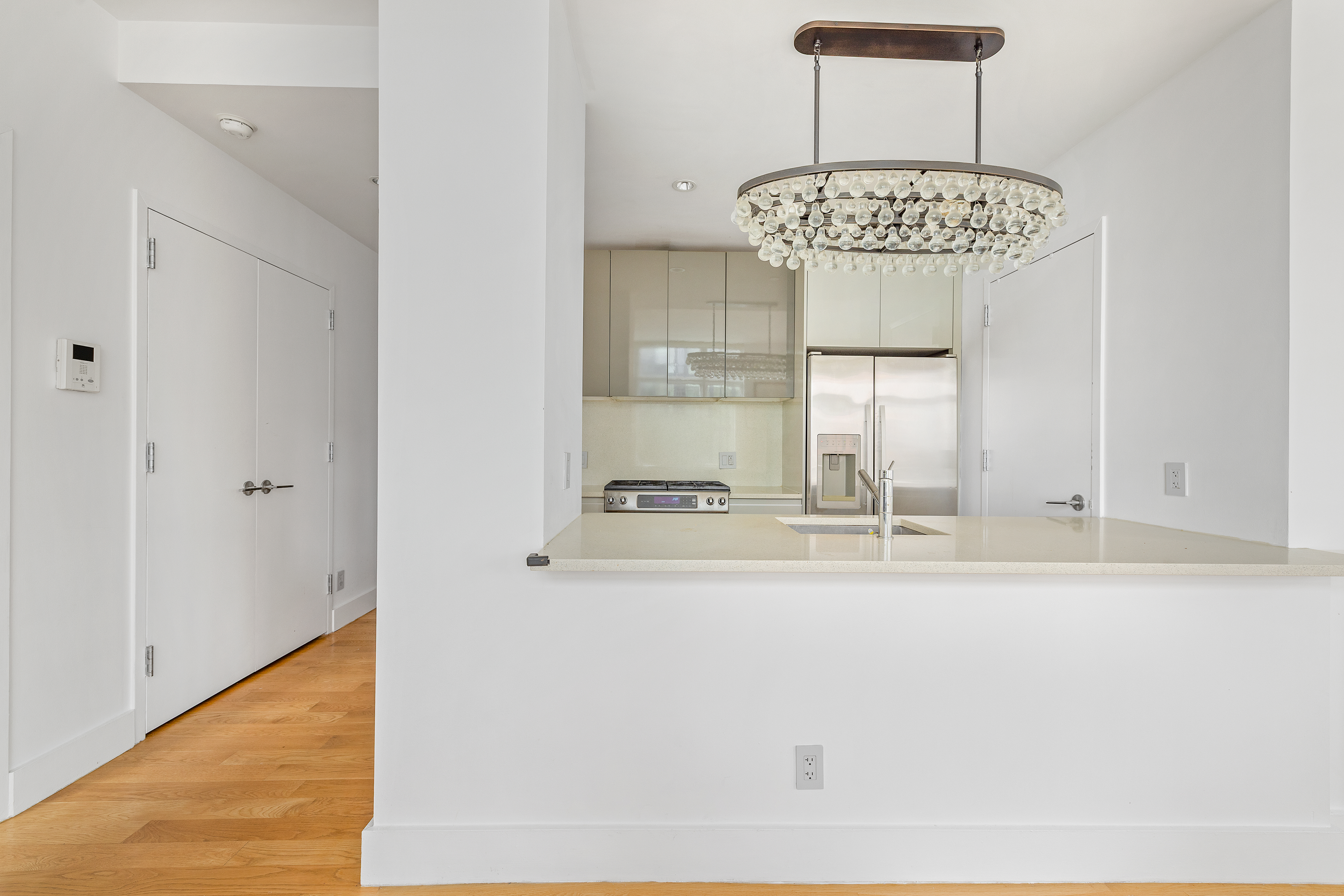 2-26 50th Avenue, Unit 10F Queens, NY 11101 - Photo 6 of 11 a view of a kitchen from a dining room