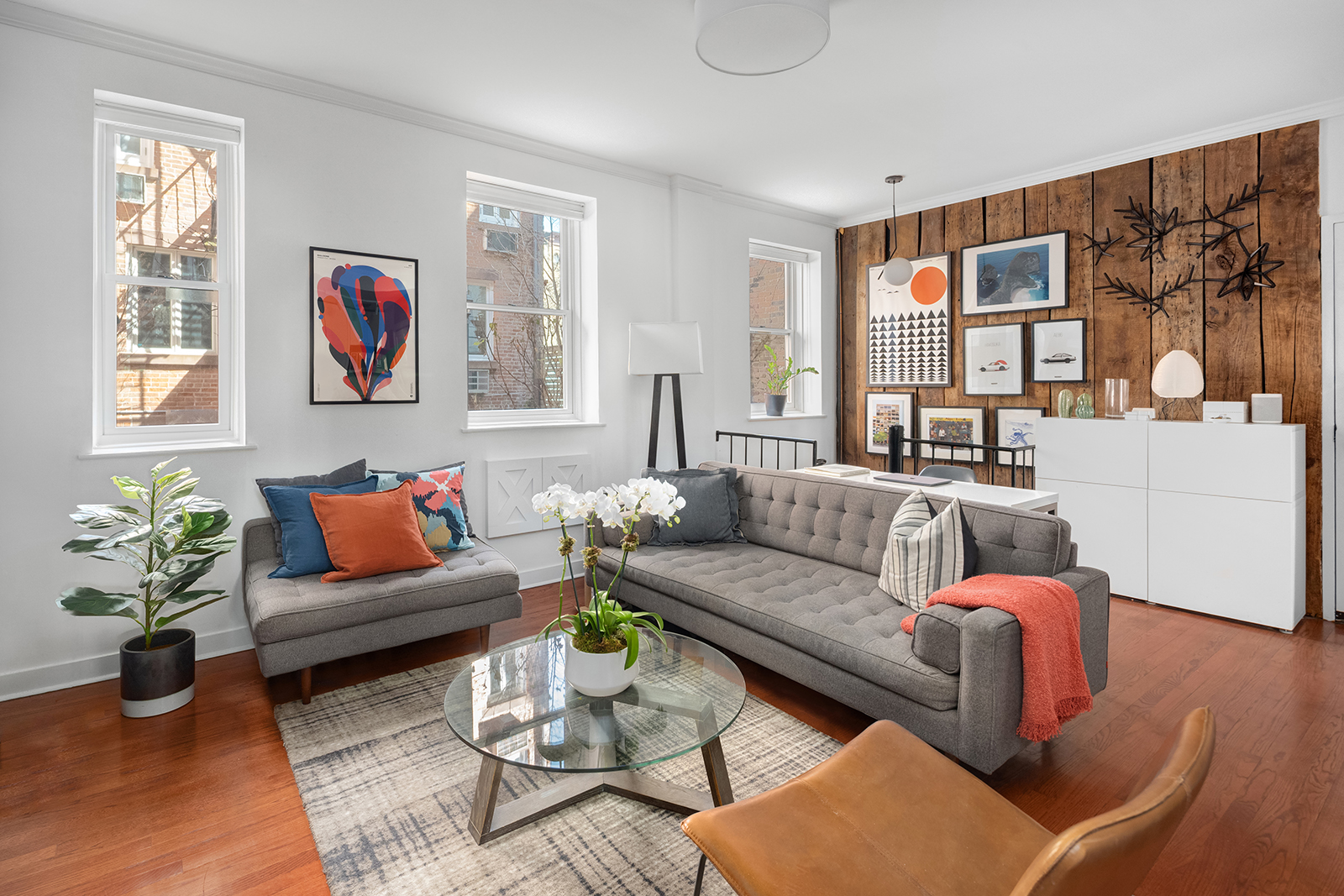 337 West 20th Street, Unit 1B Manhattan, NY 10011 - Photo 1 of 11 a living room with furniture or couch and a window