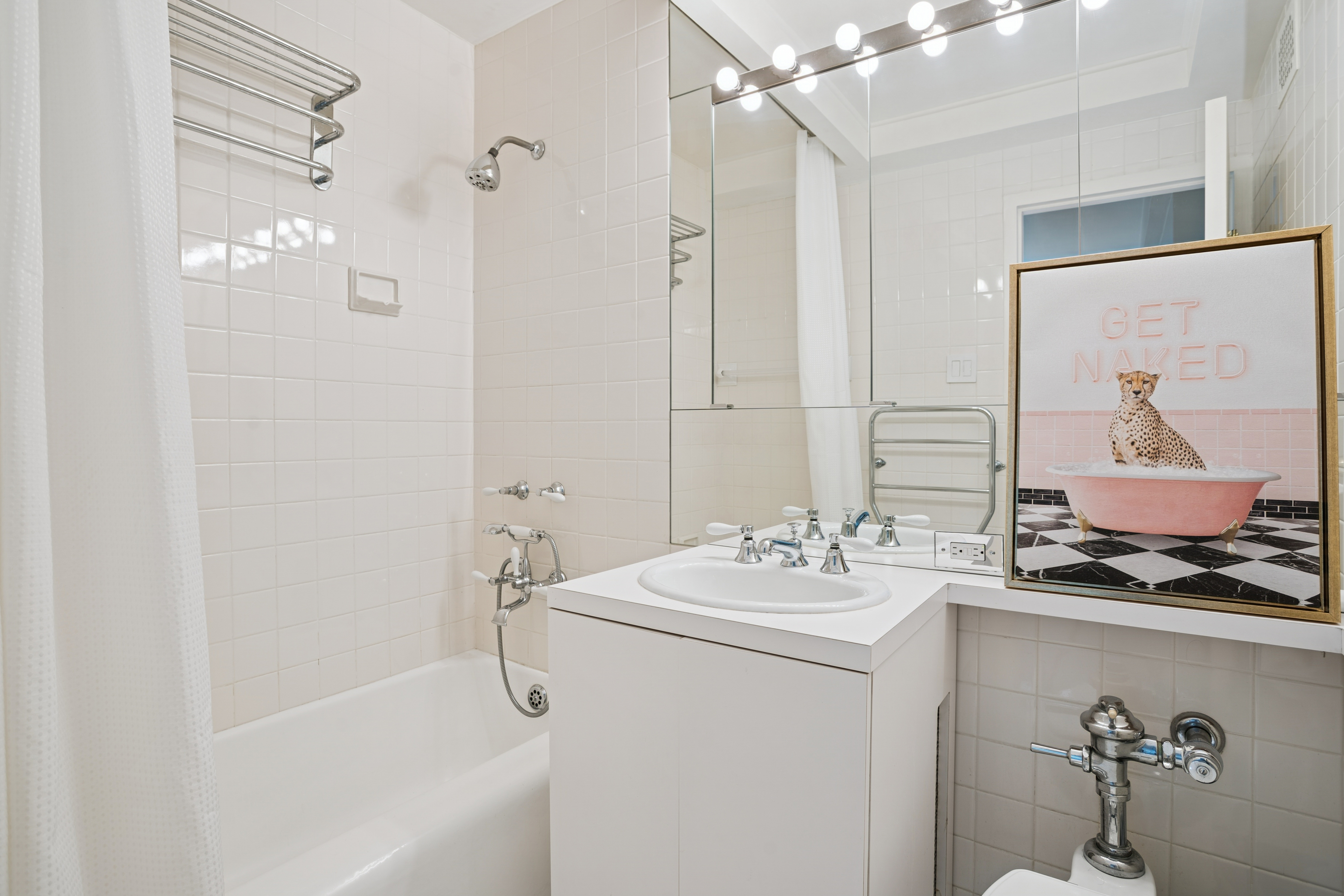 440 East 56th Street, Unit 6FGH Manhattan, NY 10022 - Photo 11 of 18 a bathroom with a sink vanity tub and shower